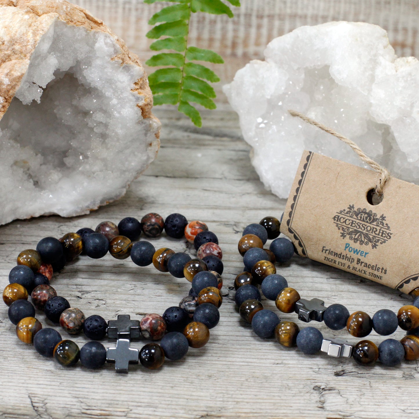 Gemstone friendship bracelets set with multicoloured beads and cross charms displayed on wooden surface