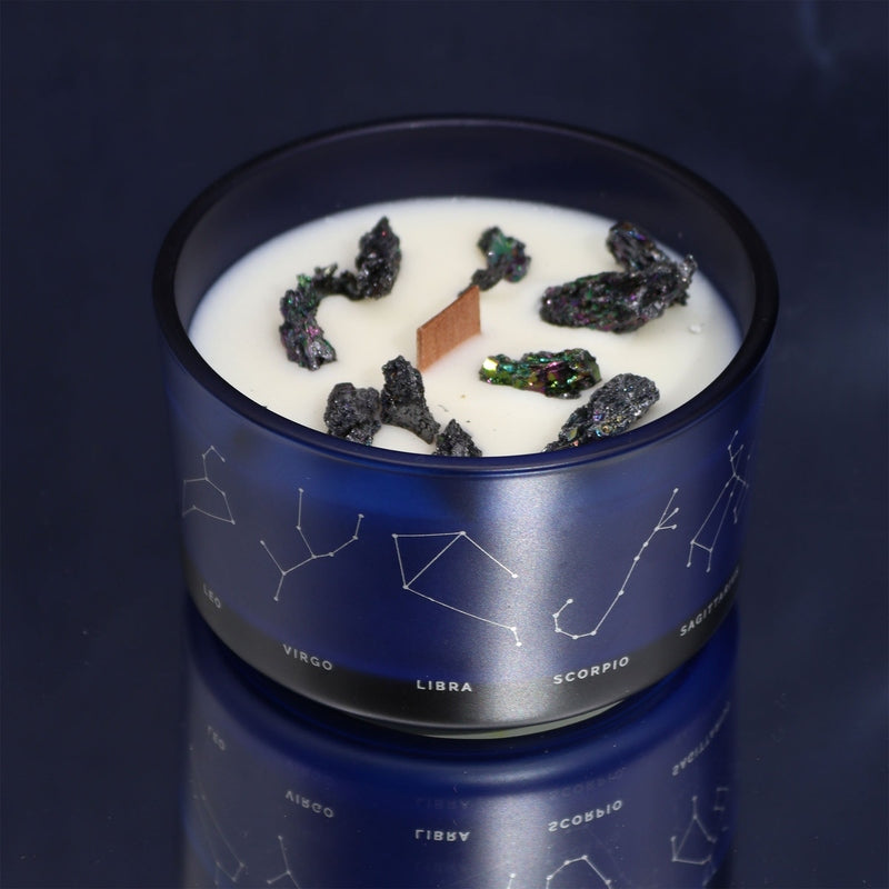 Aquarius astrology candle with crystals by Samsara Wellbeing in a blue container featuring zodiac constellations