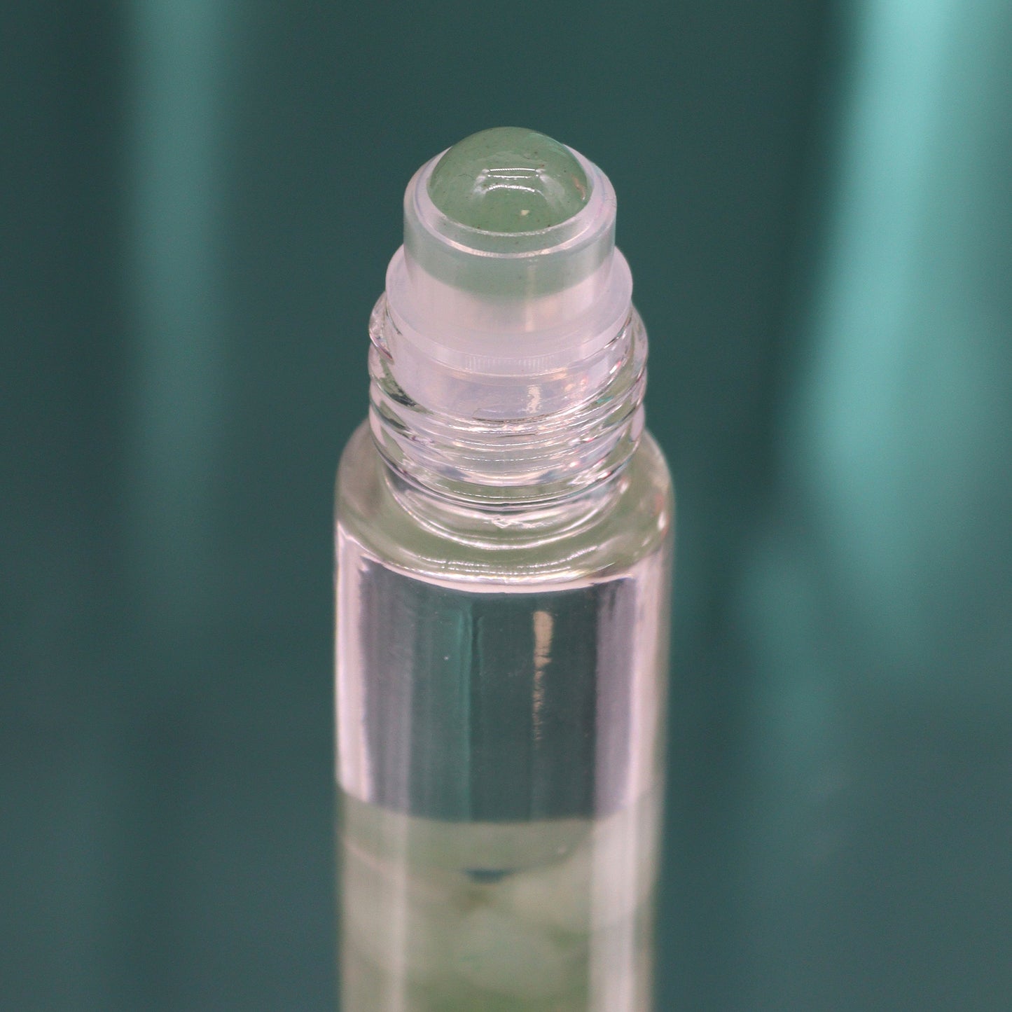 Close-up of clear glass bottle with roll-on applicator for tarot essential oil roll on