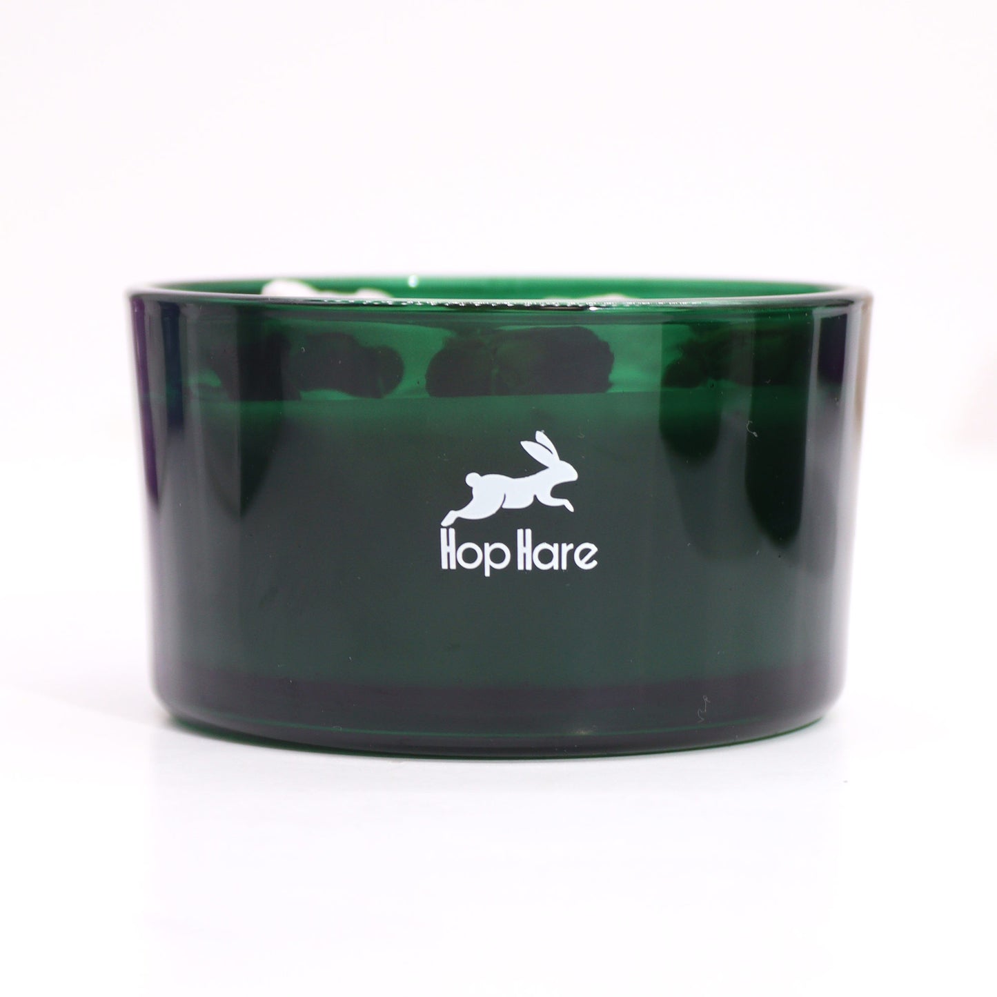 Green glass jar crystal infused flower candle by My Store with Hop Hare logo on front