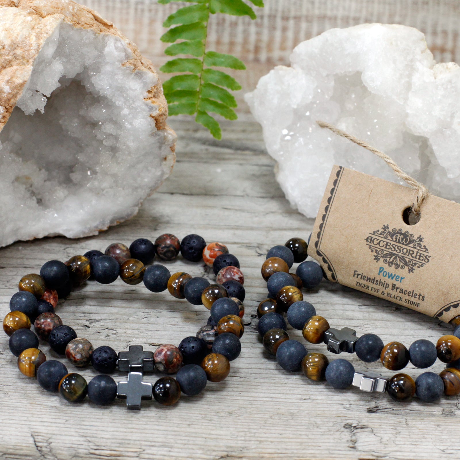 Gemstone friendship bracelets set with multicoloured beads and cross charms displayed on wooden surface