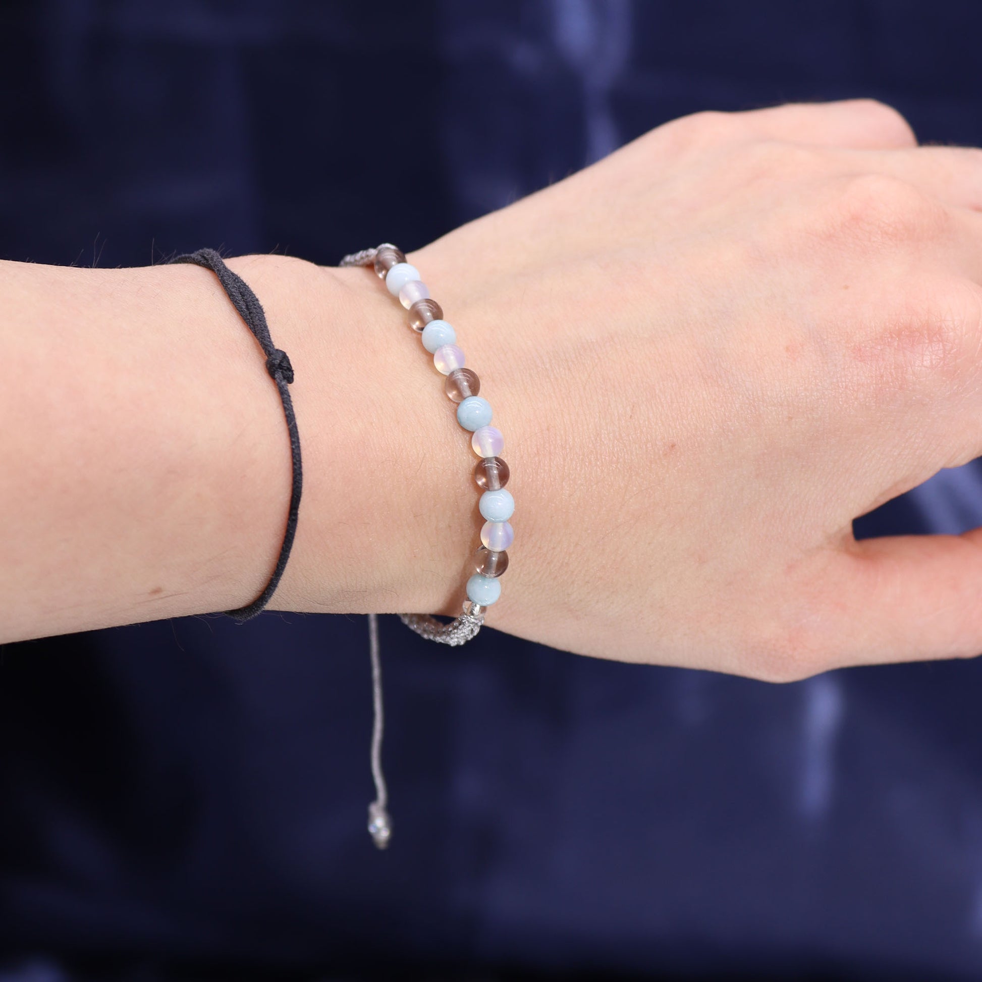 Cancer zodiac crystal candle bracelet with mixed gemstone beads by Samsara Wellbeing on wrist
