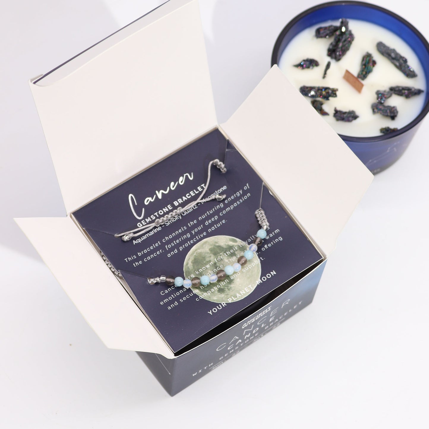 Cancer zodiac crystal candle by Samsara Wellbeing with gemstone bracelet and natural crystal embedded