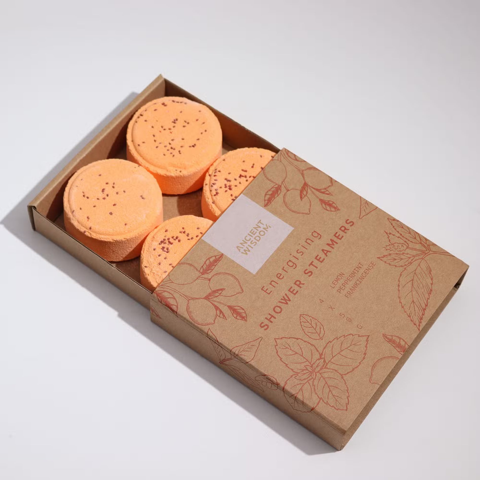Samsara Wellbeing energising shower steamers in orange with speckled texture in eco-friendly packaging
