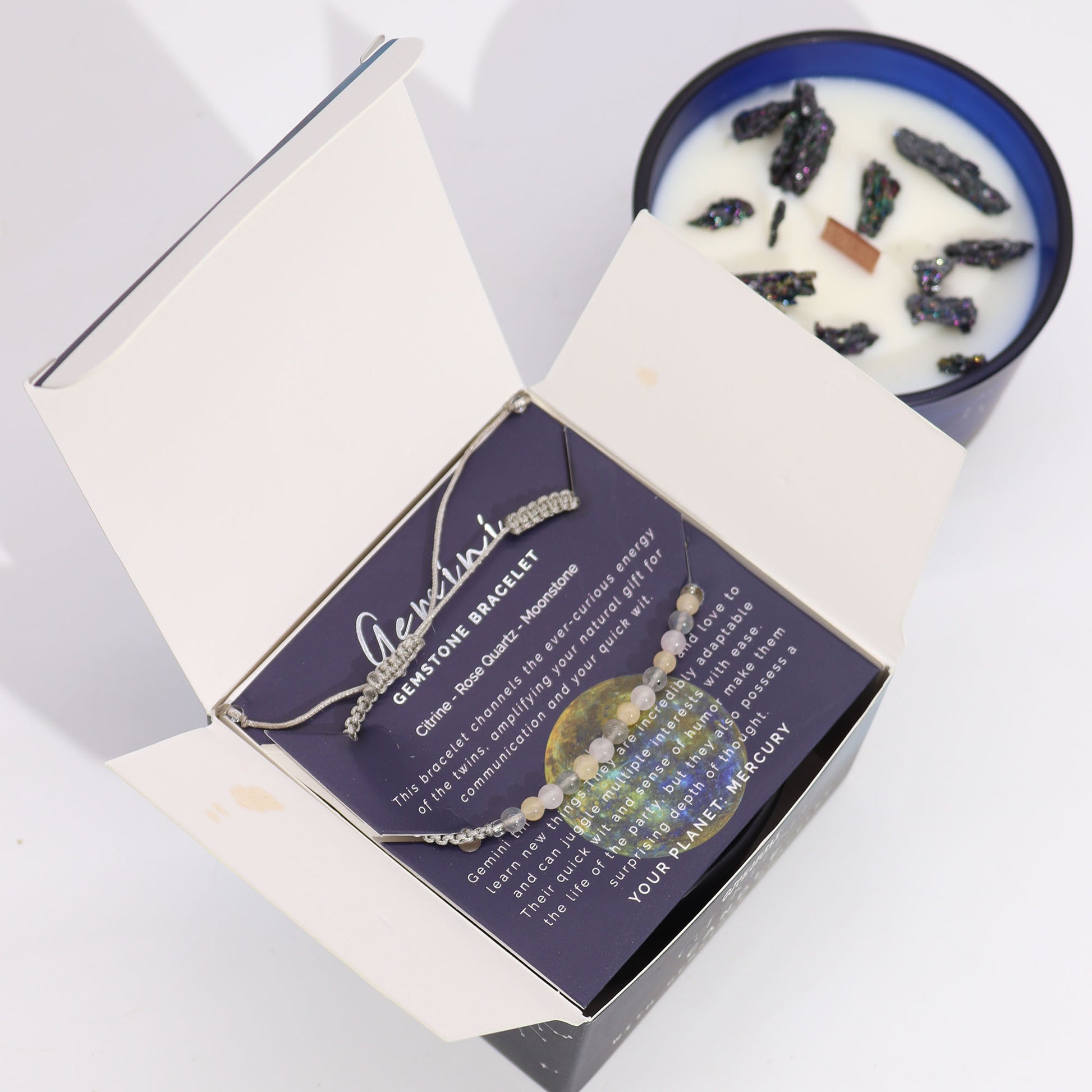 Gemini zodiac candle gift by Samsara Wellbeing with a scented candle and a gemstone bracelet in elegant packaging
