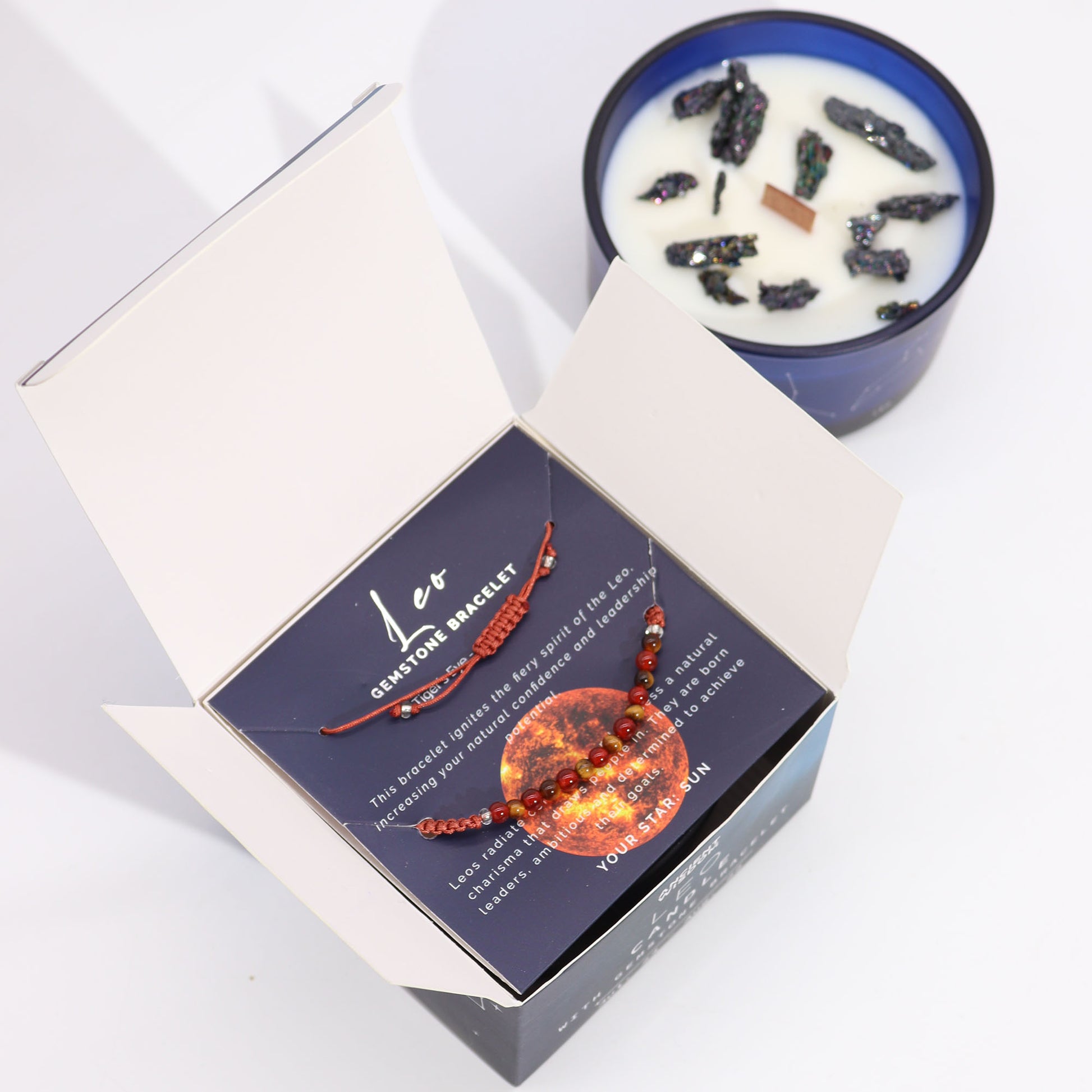 Samsara Wellbeing Leo zodiac crystal candle in blue jar with natural crystals and Leo gemstone bracelet packaging