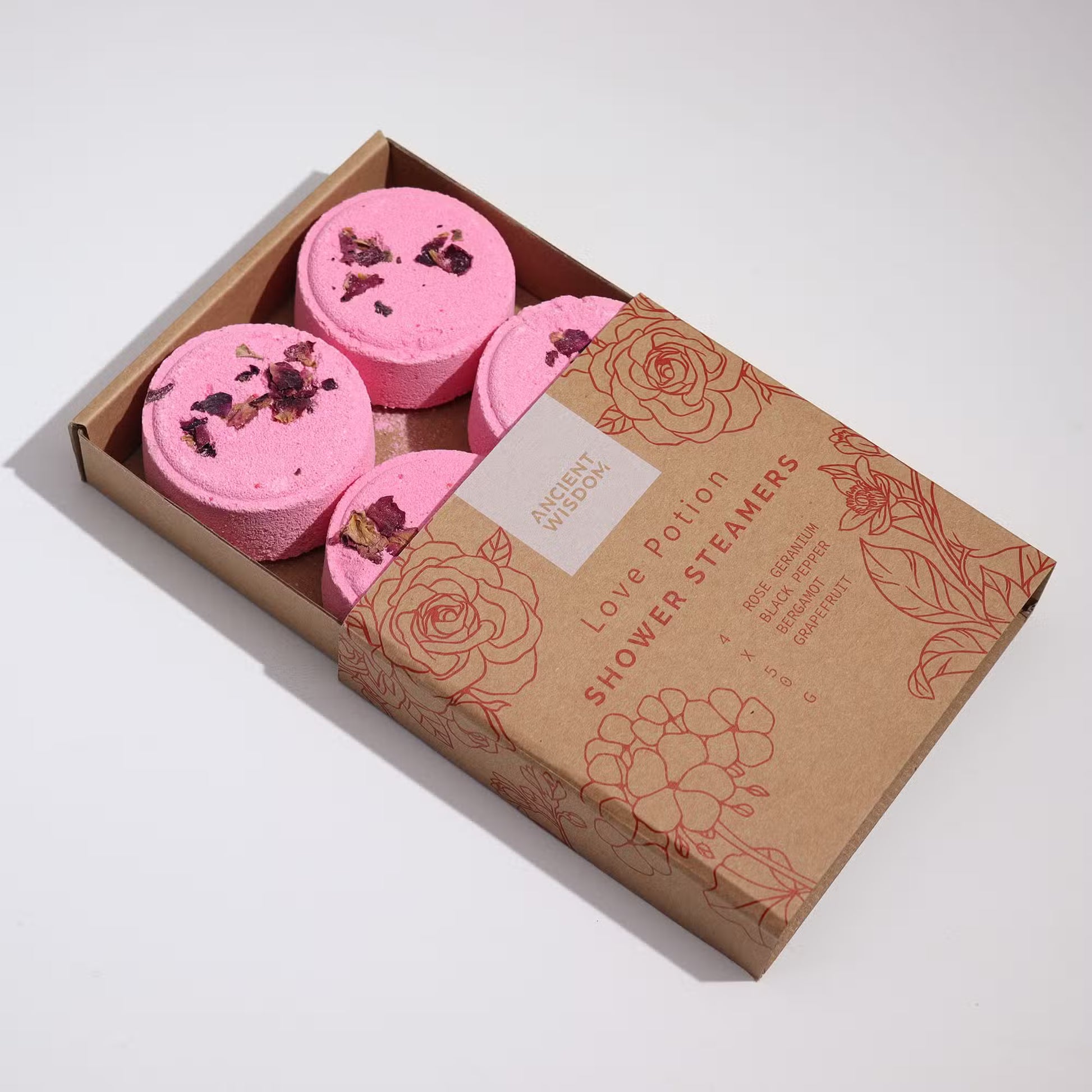 Samsara Wellbeing pink Zen shower steamers with dried petals in a brown floral printed box