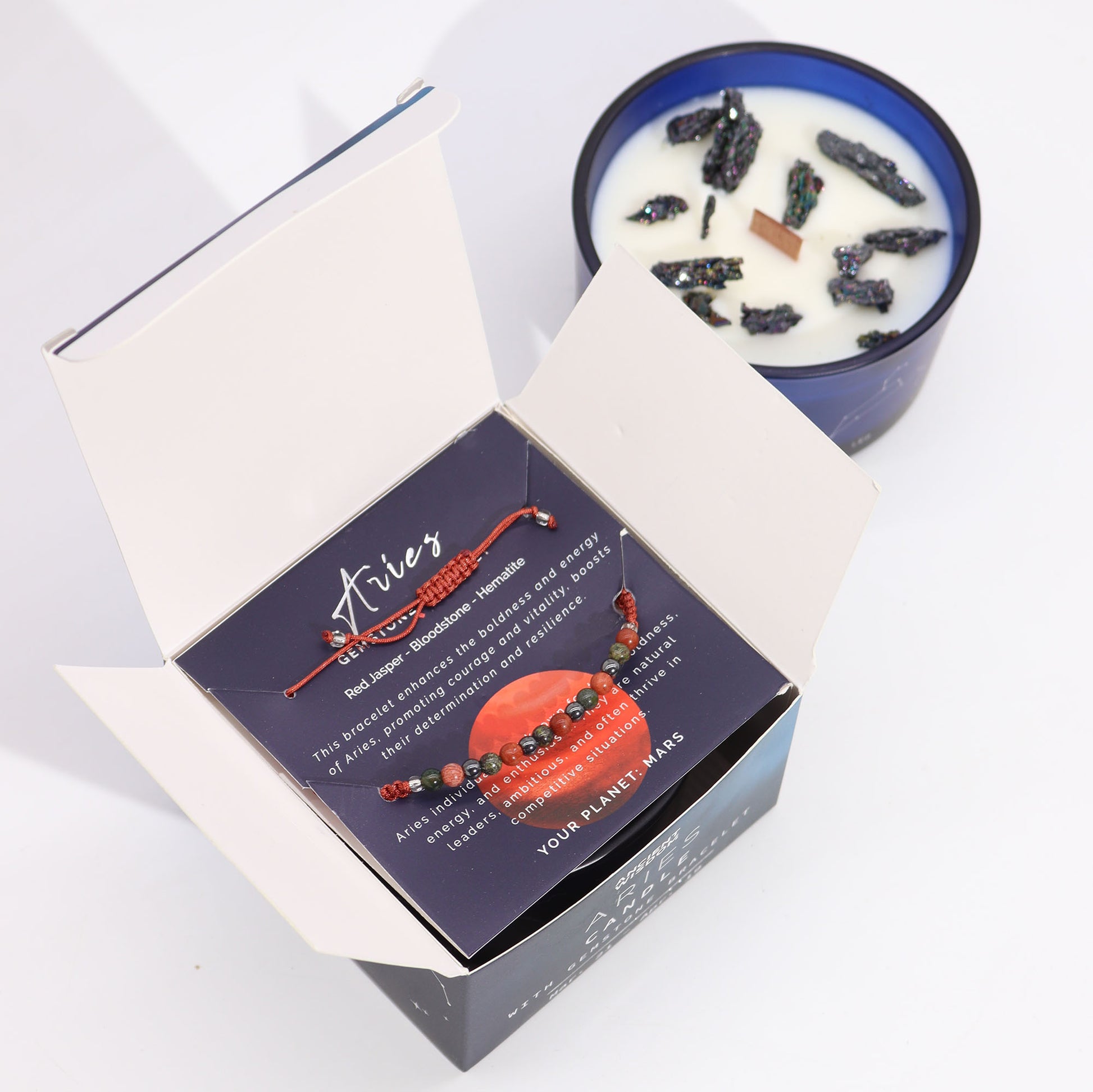 Aries zodiac crystal candle by Samsara Wellbeing with red jasper and candle in blue glass jar