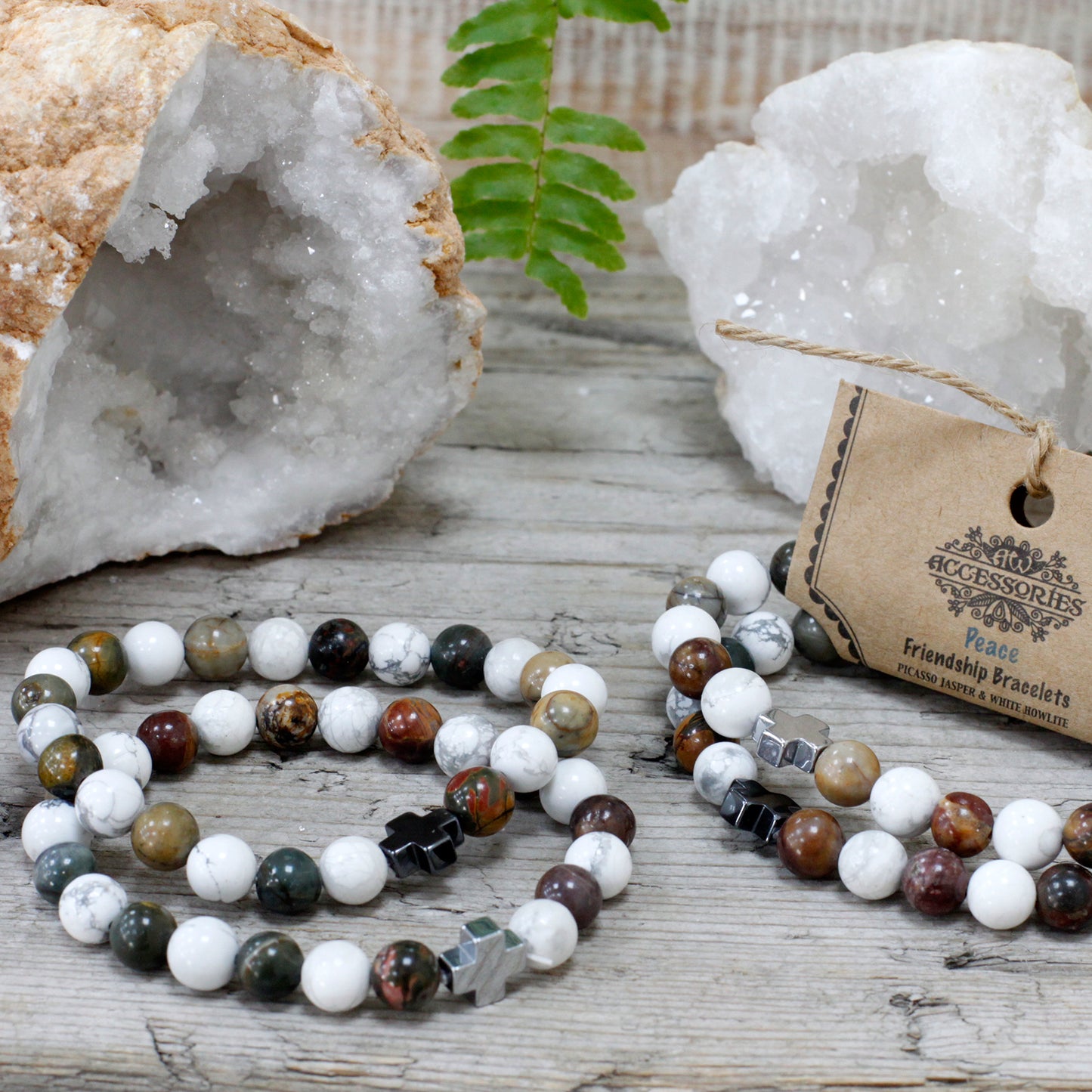 Gemstone friendship bracelets set with multicolour beads on wooden surface with crystal geodes background