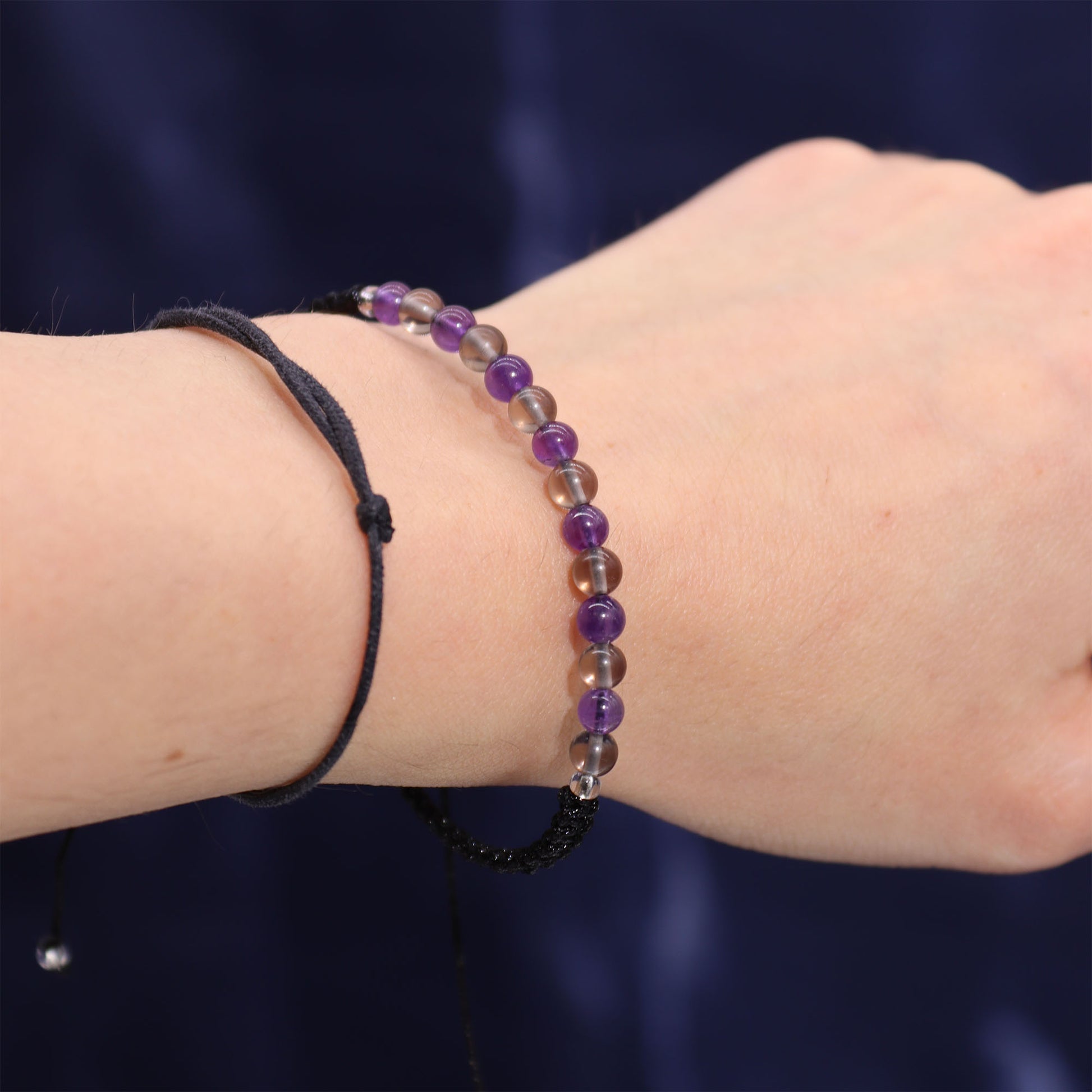 Capricorn crystal candle gift featuring a purple and clear beaded bracelet from Samsara Wellbeing
