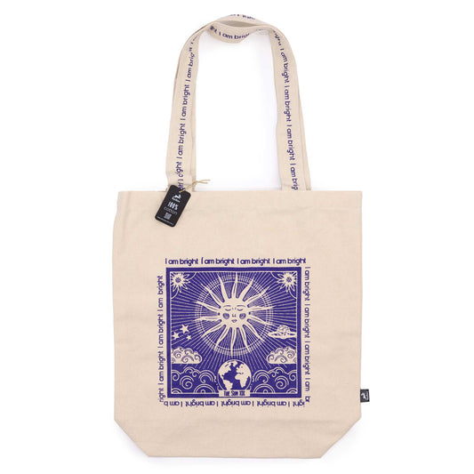 Beige cotton tote bag with print featuring sun and earth graphic and I am bright text design