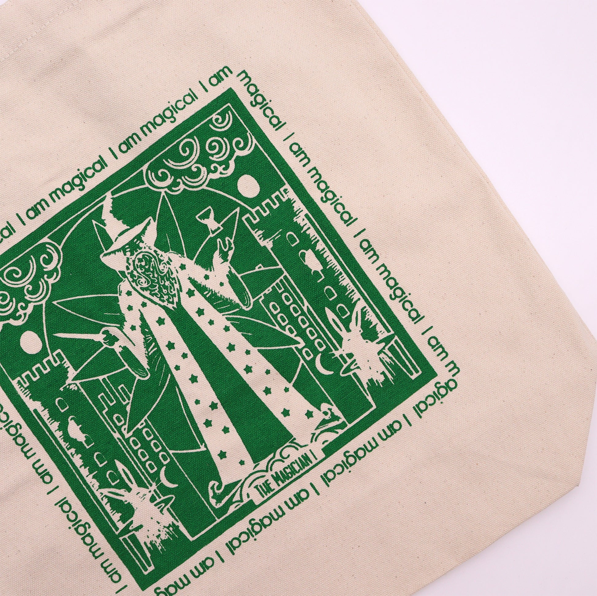 Beige cotton tote bag with wizard design in green print featuring magical motifs and text I am magical