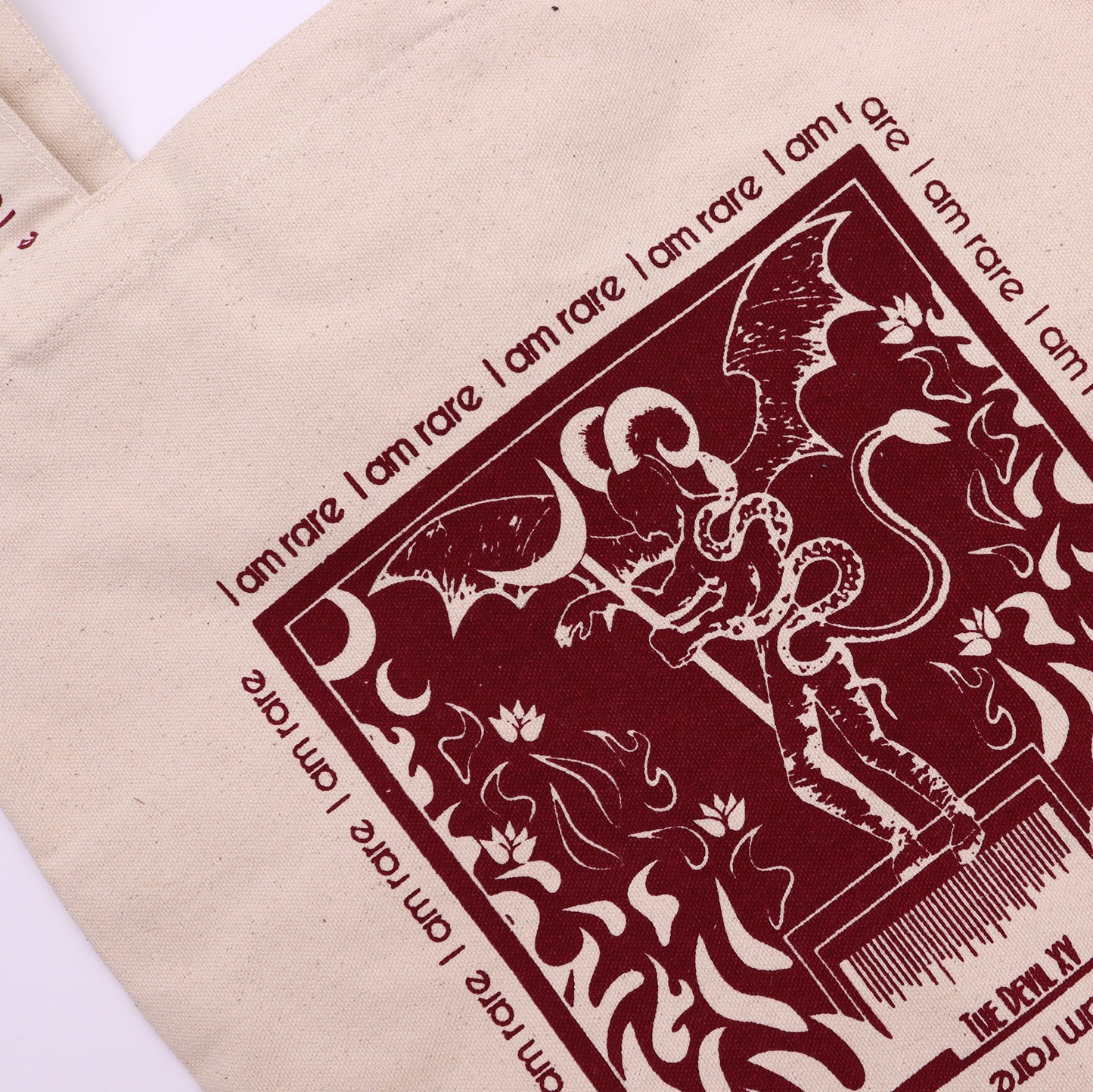 Eco friendly canvas tote bag with artistic demon and snake design in dark red print