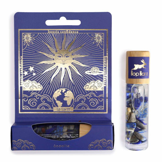 Crystal infused essential oil roller with blue sodalite stones in decorative navy and gold packaging