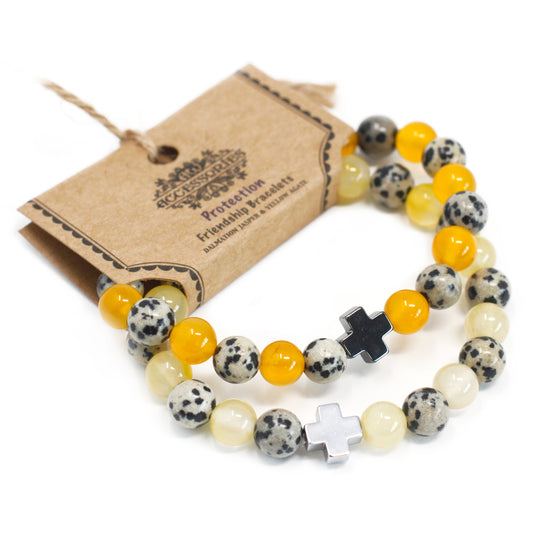 Gemstone friendship bracelets with yellow, speckled and cream beads featuring black and silver cross charms