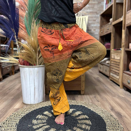 Samsara Wellbeing Himalayan print yoga pants in orange green and yellow tones with spiritual motifs