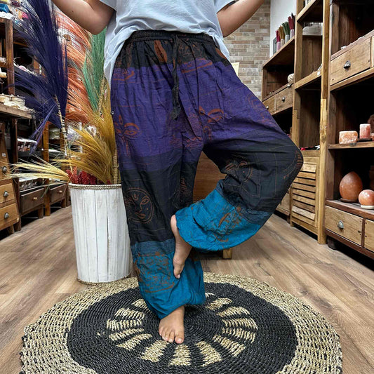 Samsara Wellbeing Himalayan print yoga pants in blue and purple worn indoors on wooden floor