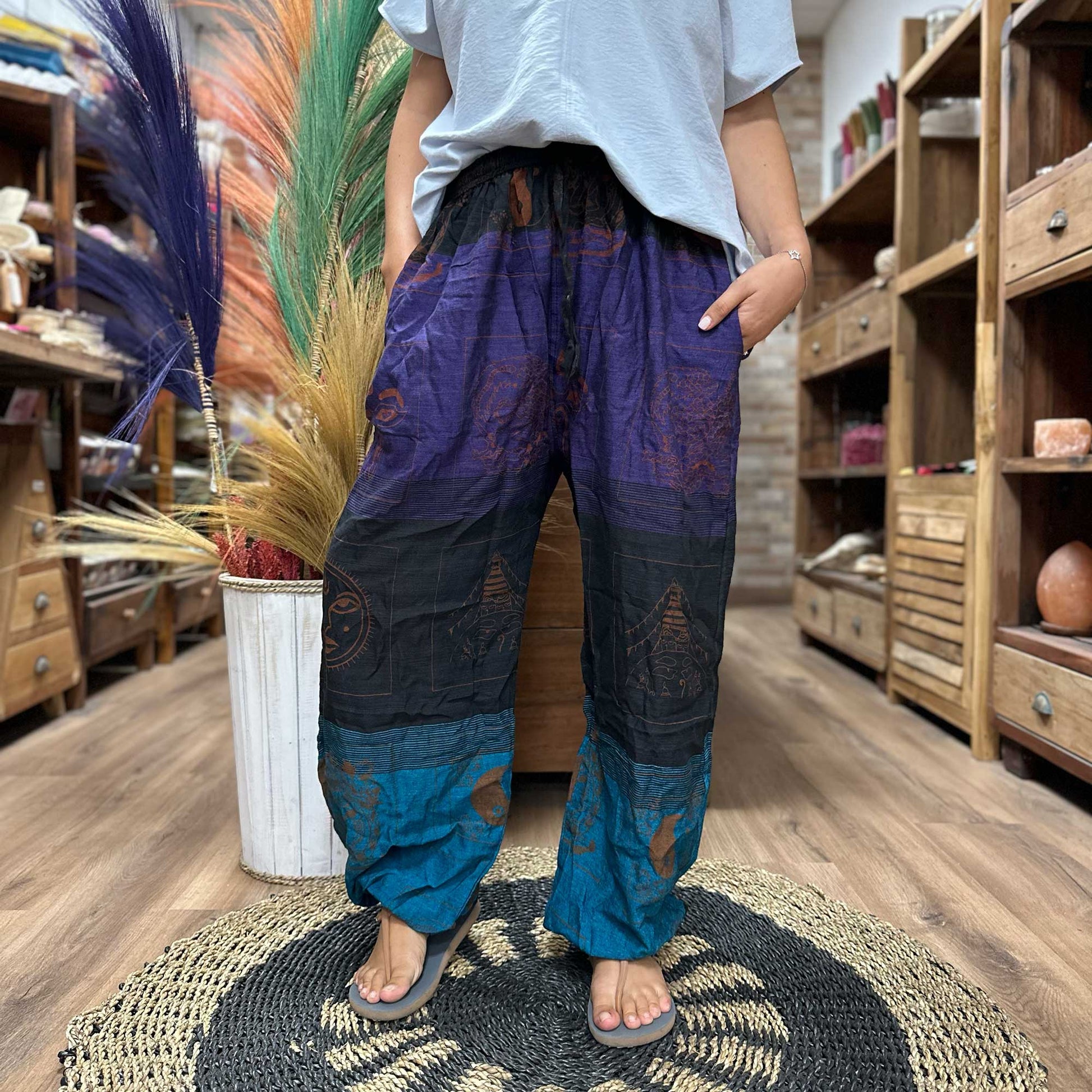 Samsara Wellbeing Himalayan print yoga pants in blue and purple worn with casual t-shirt indoors