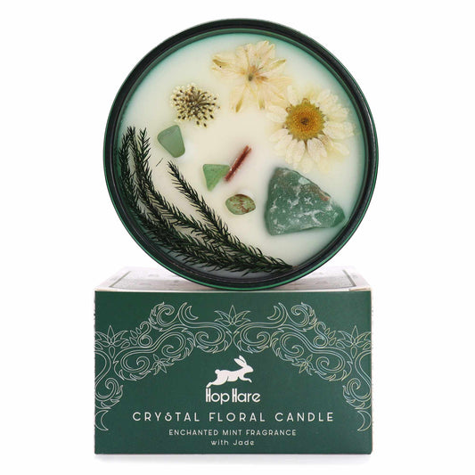 Crystal infused flower candle with dried flowers and jade crystals in a green decorative container