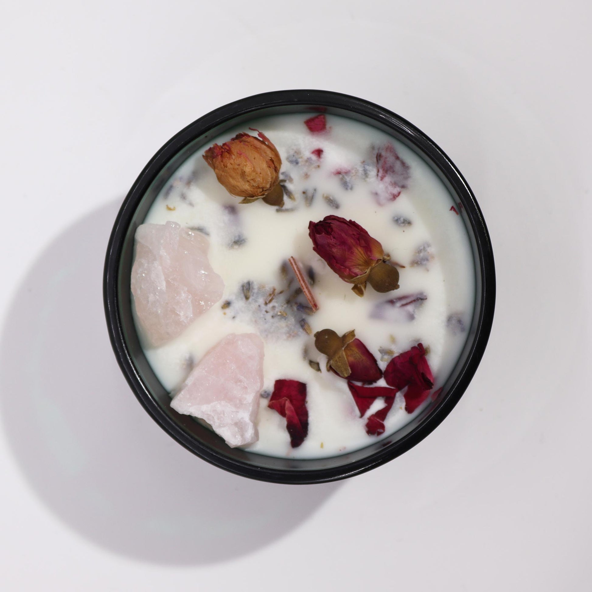 Crystal magic flower candle with dried rosebuds and crystals in black container