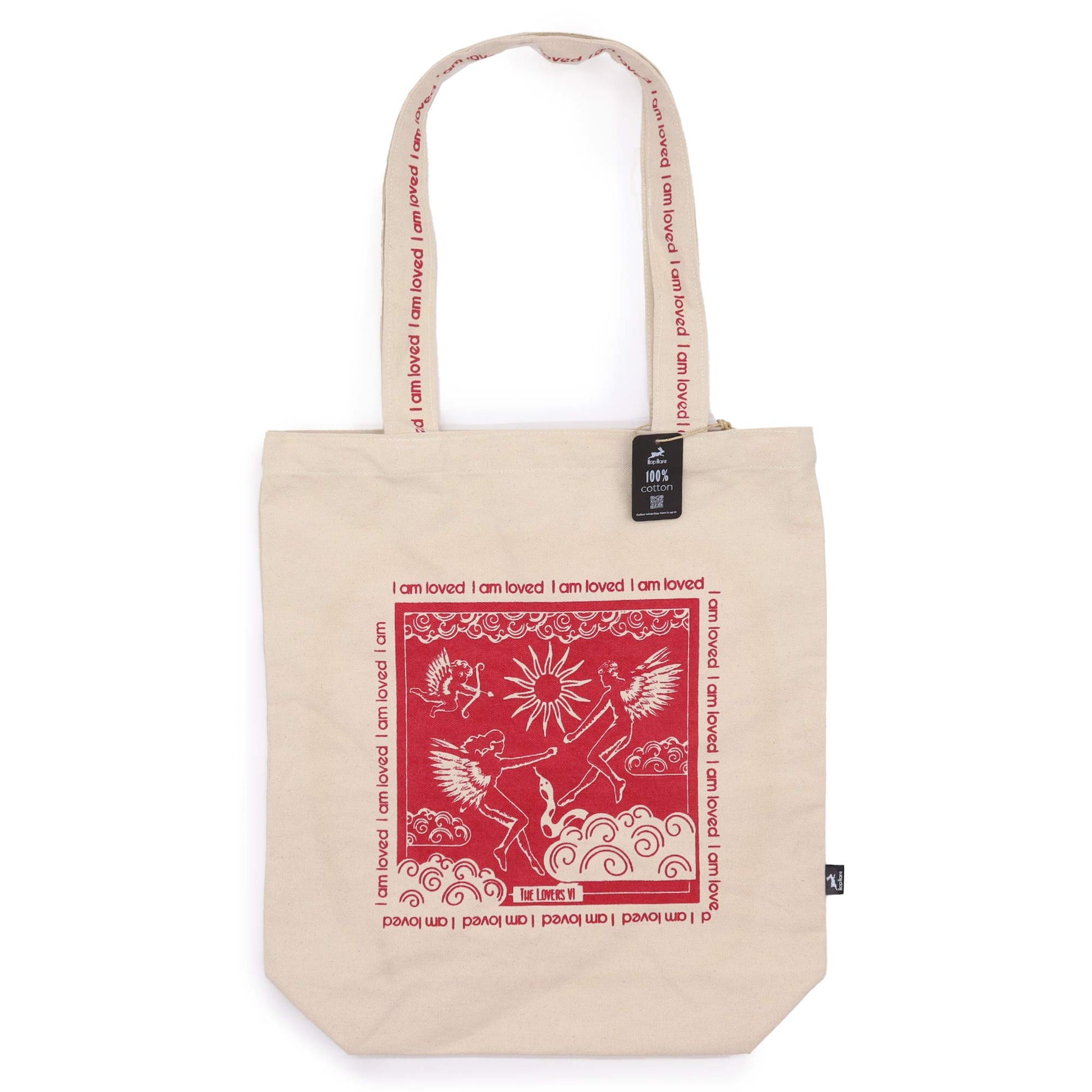 Beige tote bag featuring red artistic design and I am Loved affirmation bag text on handles and front