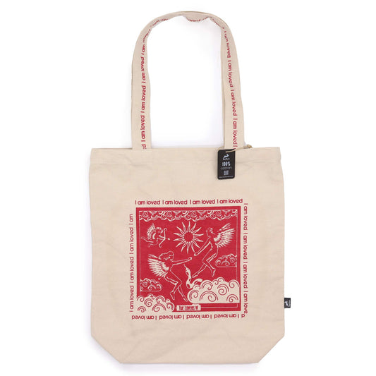 Beige tote bag featuring red artistic design and I am Loved affirmation bag text on handles and front
