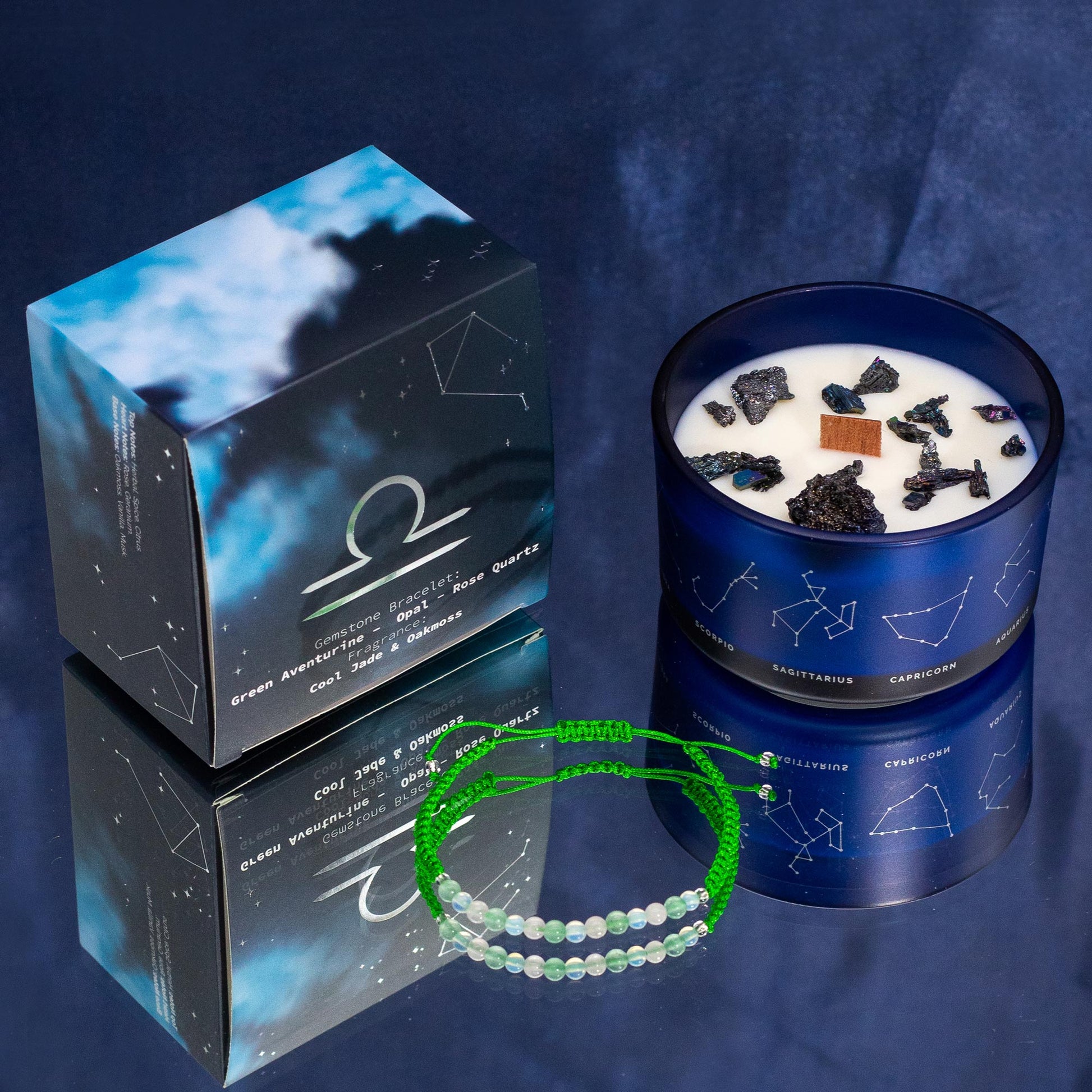 Libra zodiac crystal candle by Samsara Wellbeing with constellation design and crystal stones in dark blue glass