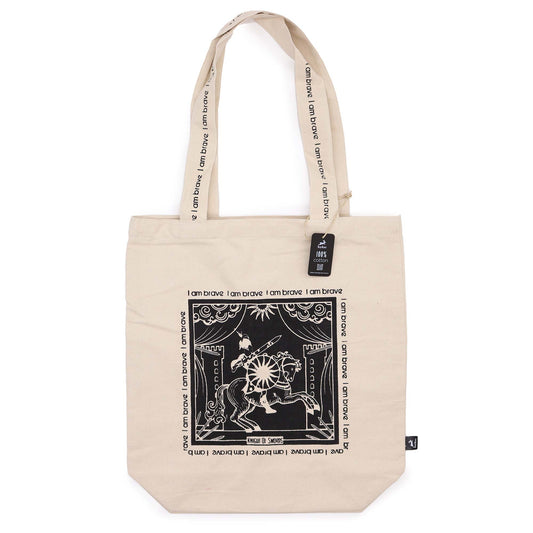 Beige motivational tote bag with I am brave text and black graphic design on front and handles