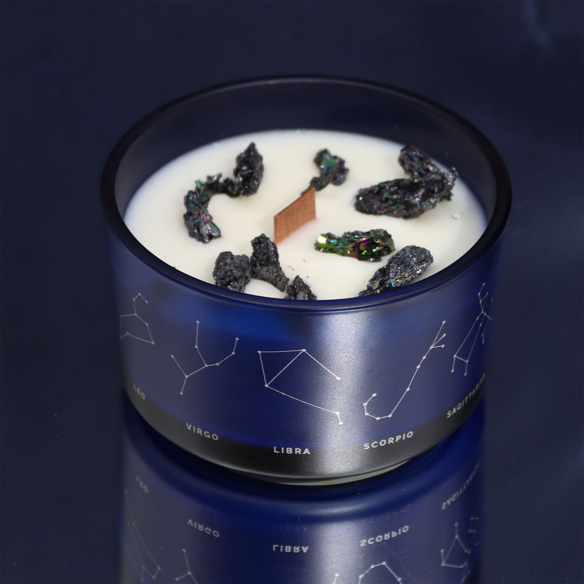 Samsara Wellbeing Pisces crystal candle in a blue glass container with zodiac constellations design