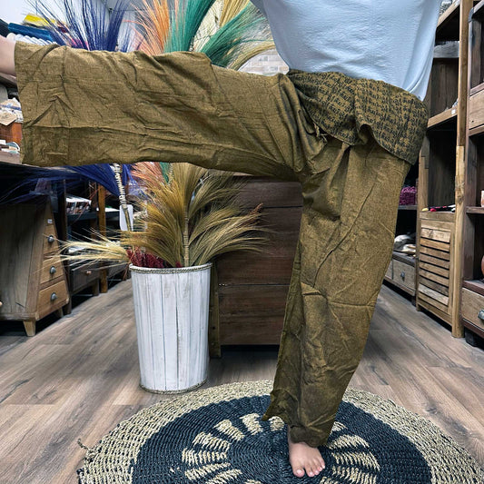 Samsara Wellbeing brown Thai fisherman pants for yoga with wide legs and adjustable waist shown indoors