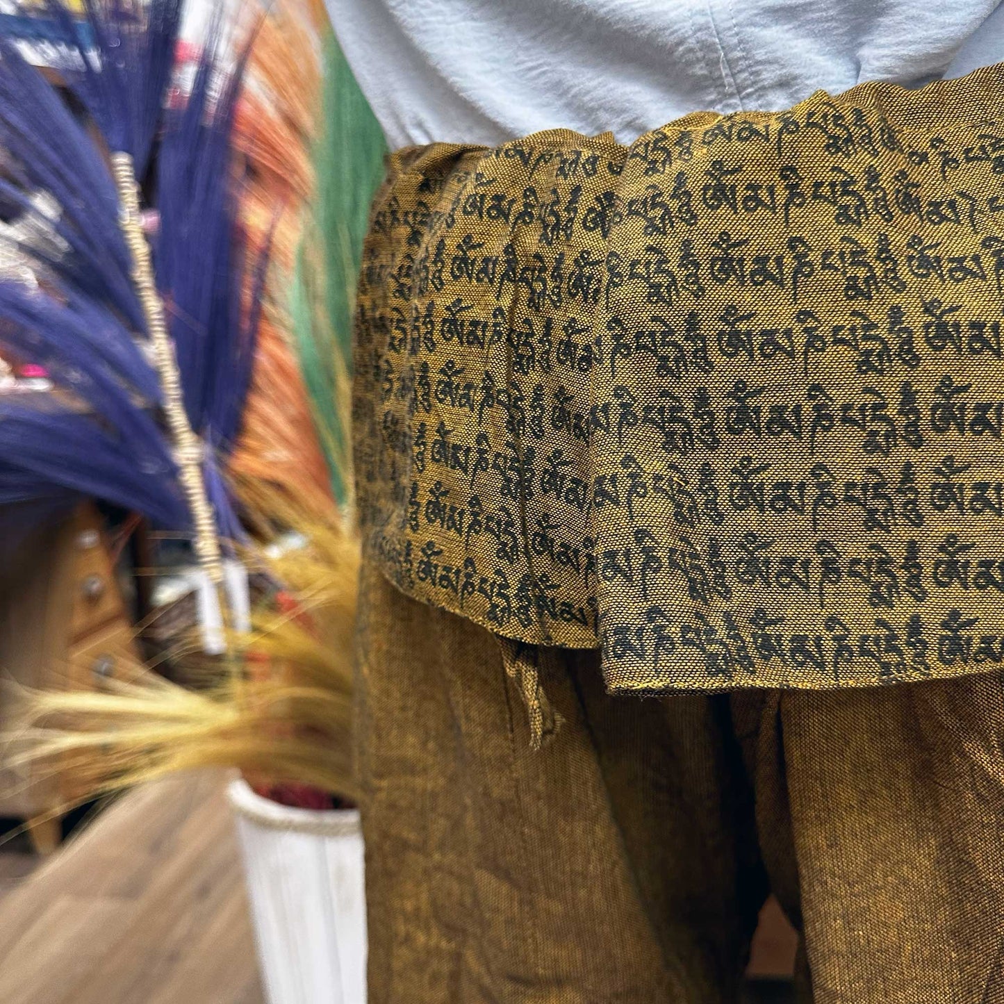 Brown Thai fisherman pants for yoga with black script design on fabric waist by Samsara Wellbeing