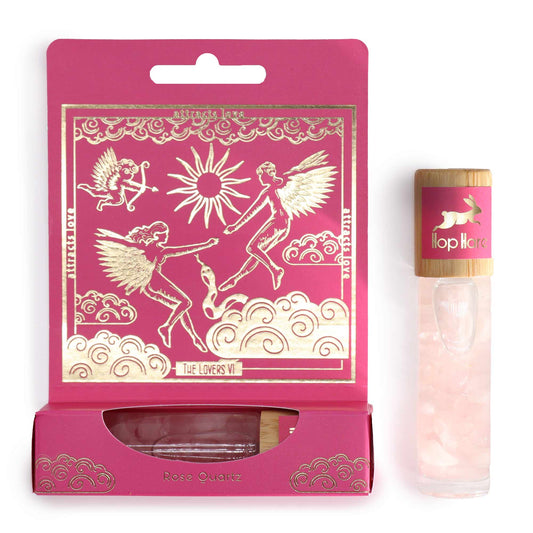 The lovers aromatherapy roller with rose quartz in a pink decorative box featuring angelic illustrations