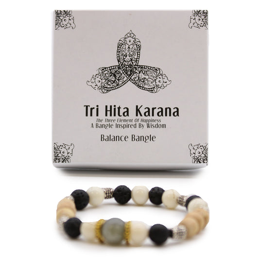 Balance gemstone bangle with mixed beads displayed in front of Tri Hita Karana themed packaging box